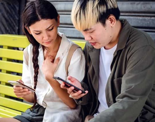 Couple working on phone Couple working on phone