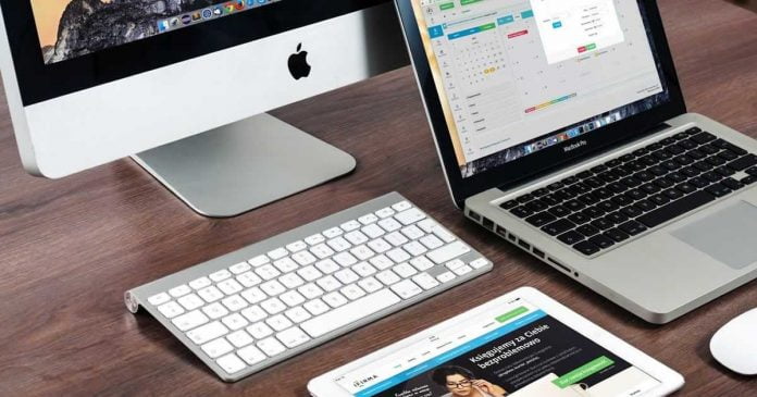 Modern IR website workstation showing iPad MacBook and Mac computer Modern IR website workstation showing iPad MacBook and Mac computer